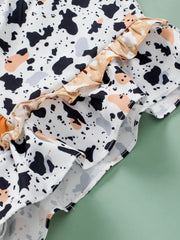 White blouse with terrazzo print and ruffled yoke detail.