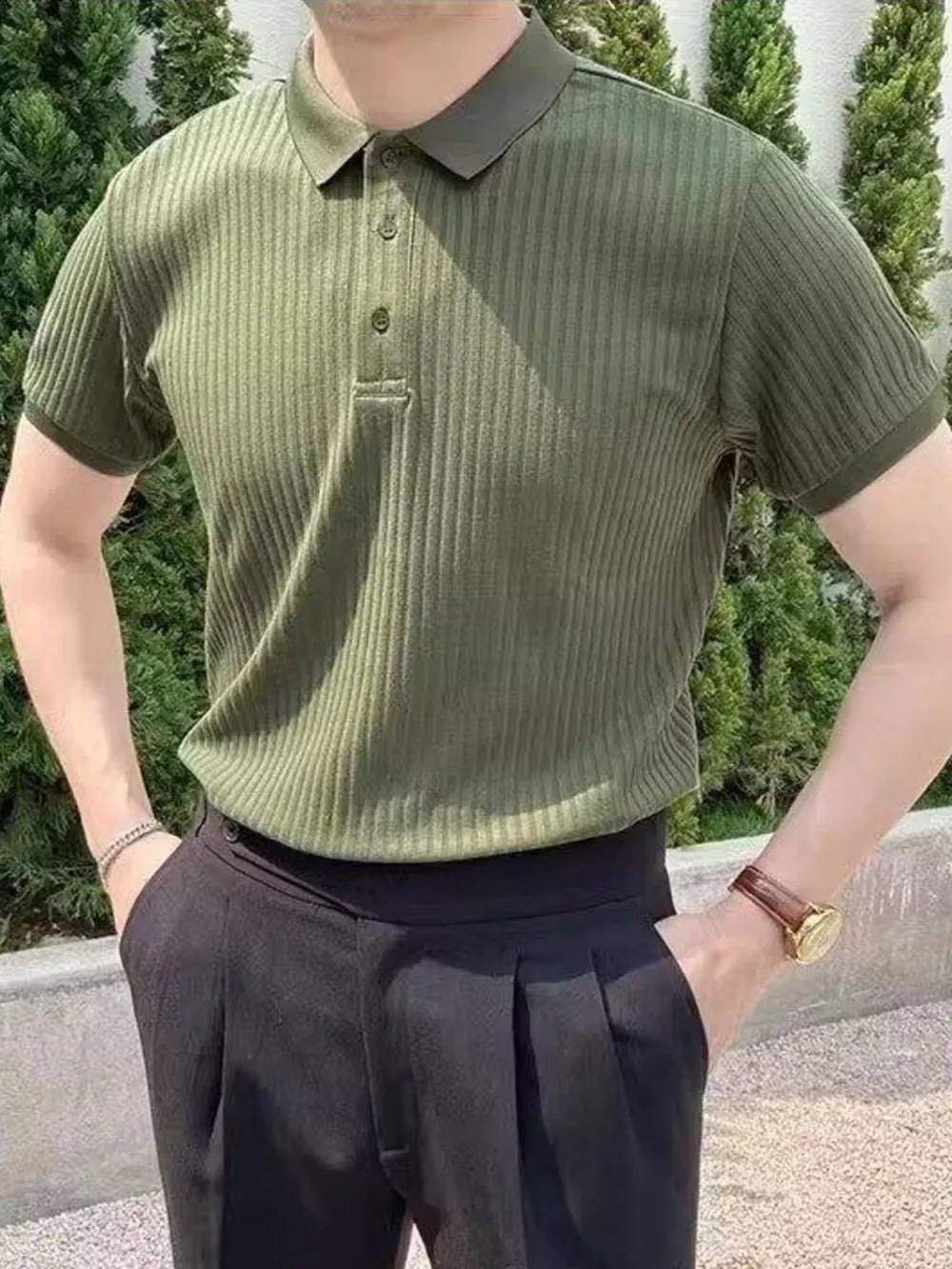 Green ribbed cotton polo shirt with button details and short sleeves.