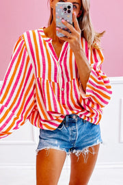 Textured stripe blouse in red with gathered sleeves and button front, styled with denim shorts.
