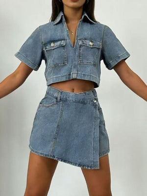 Light wash denim cropped button-down top and mini skort set with short sleeves and chest pockets.
