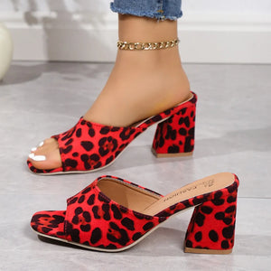 Leopard print block heel mules in deep red with open toe and square heel.