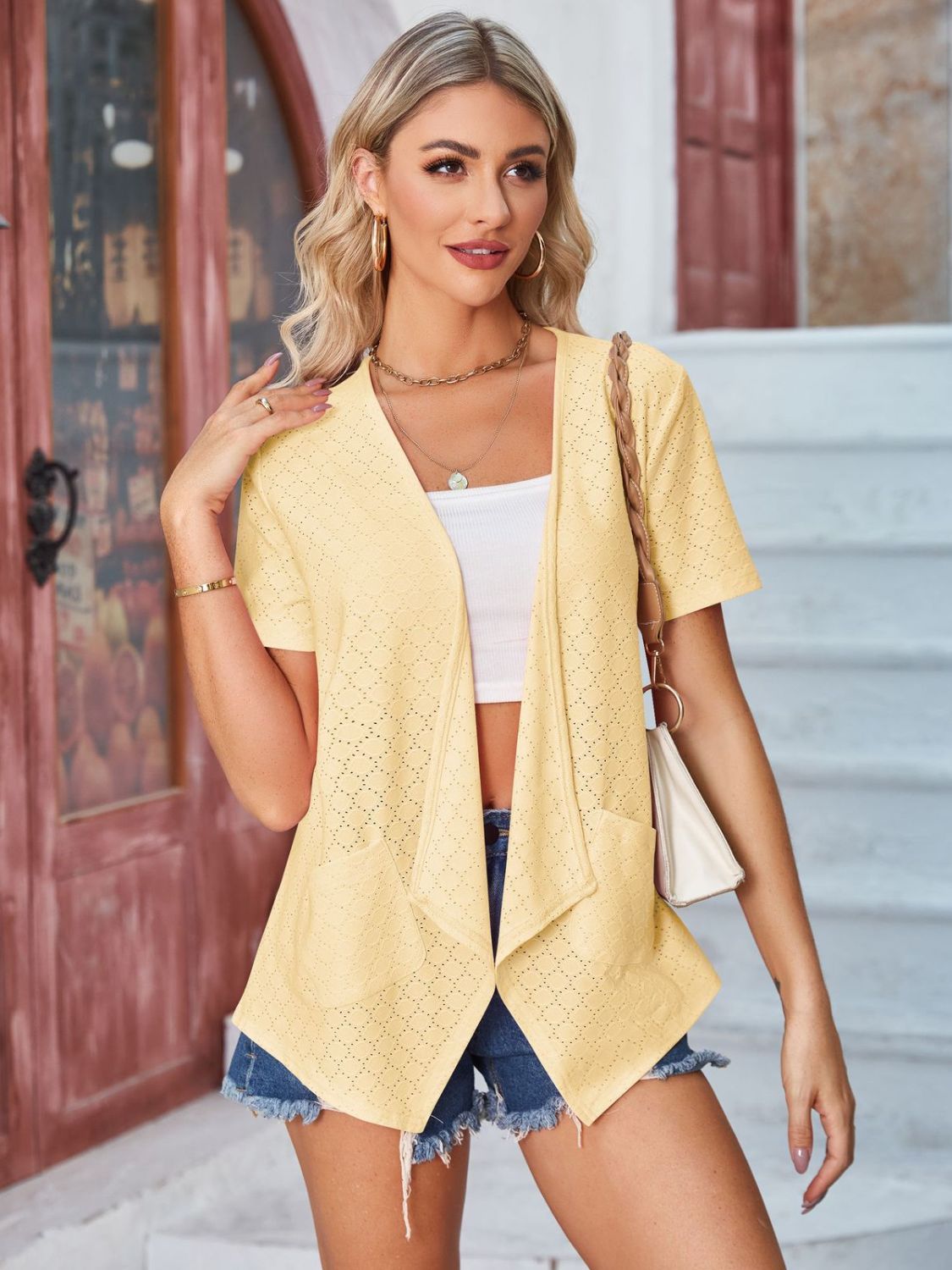 Light yellow perforated shawl collar jacket with short sleeves and pockets