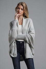 Light gray acrylic cocoon knit sleeve cardigan with open front and textured sleeves.
