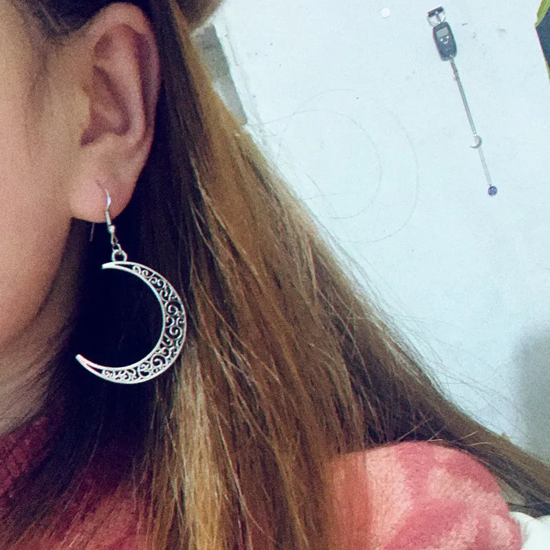 Filigree crescent drop earrings in Moon color, featuring intricate cutouts and a boho style.