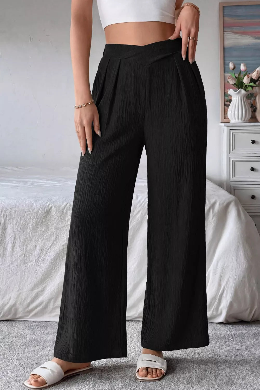Black textured wide-leg maternity pants with crossed waist detail