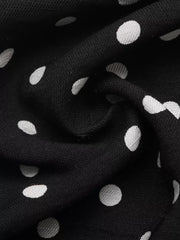 Black polka dot dress fabric with a ruffled hem detail