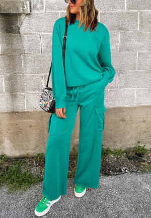 Turquoise cargo pocket lounge set with crewneck sweatshirt and wide-leg pants.