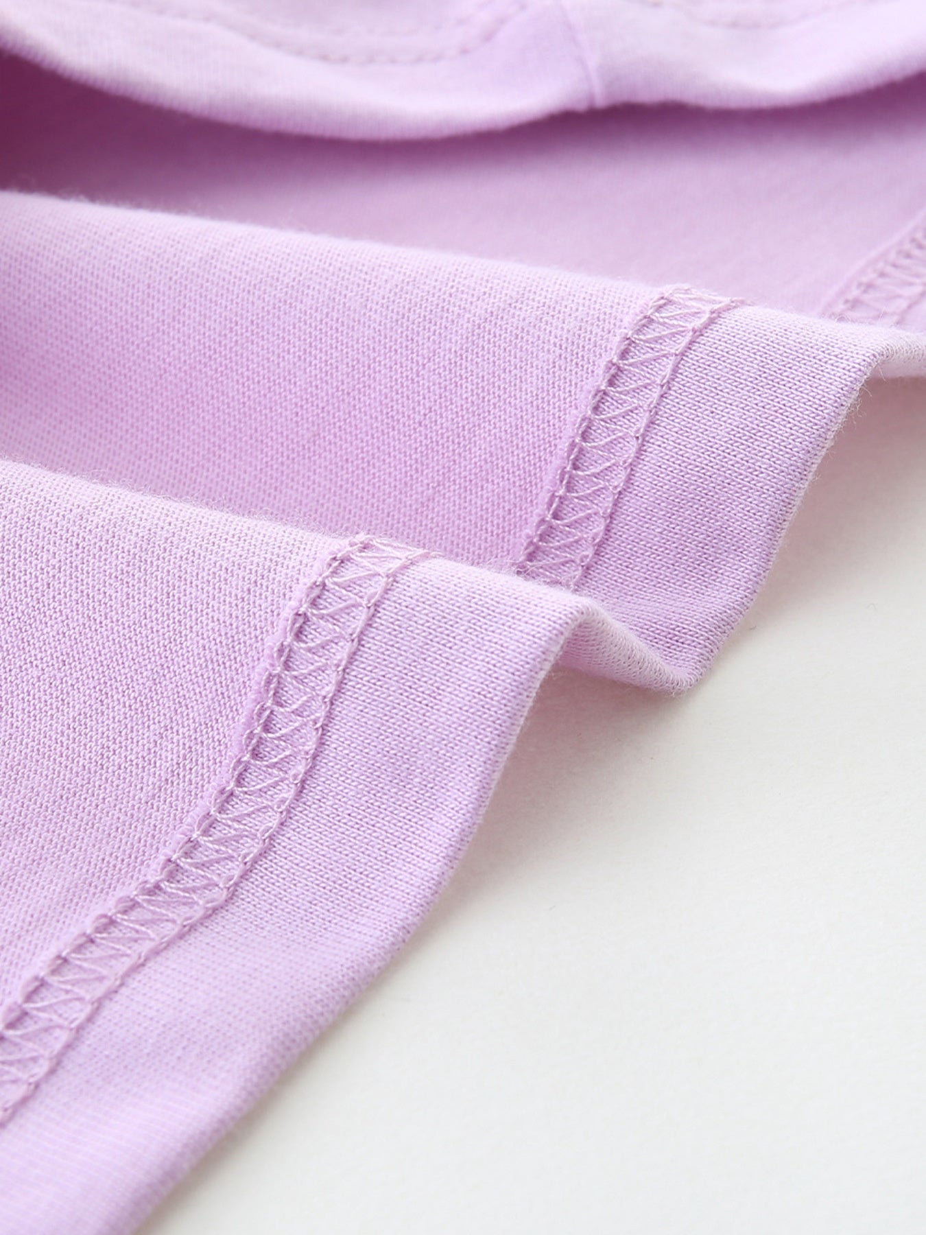 Lilac cotton toddler t-shirt detail showing stitched seams.