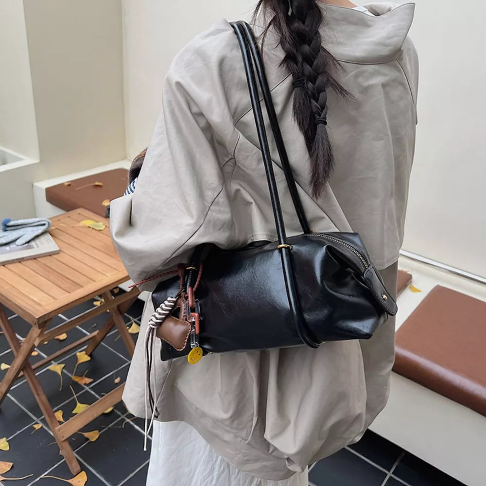 Chic black pu leather shoulder bag with charm and zipper closure