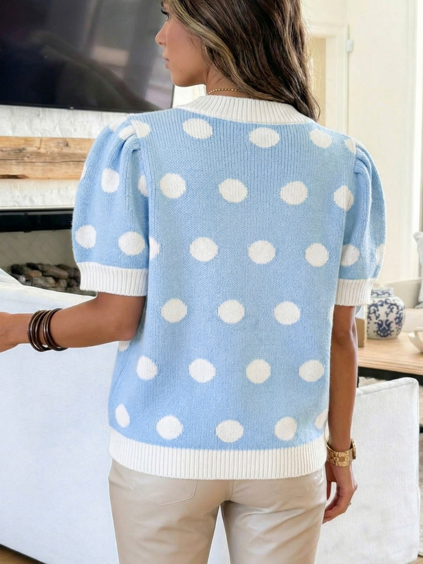 Blue polka dot knit sweater with puff sleeves and white trim