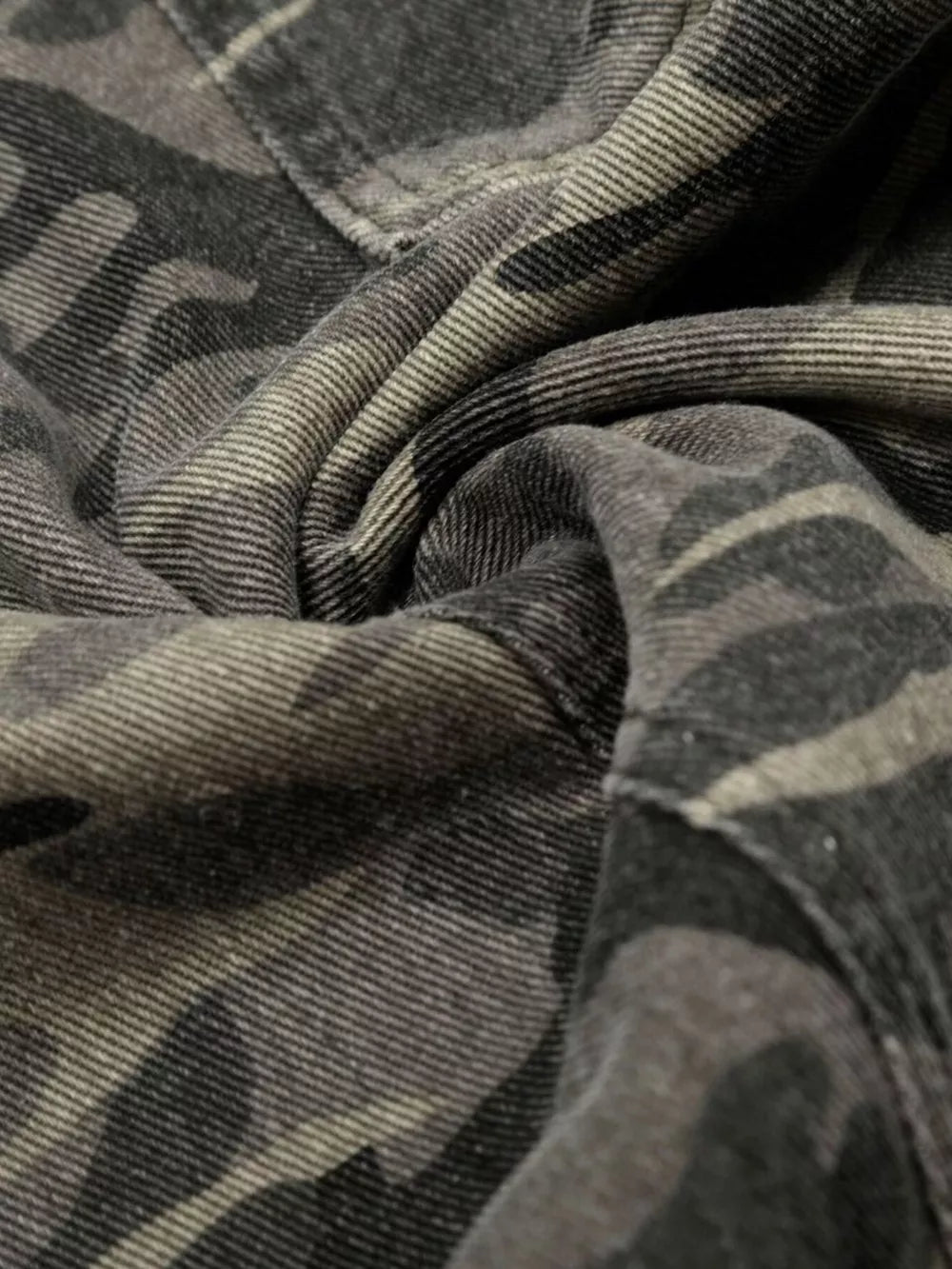 Men's cotton cargo pants in urban camouflage pattern, close-up detail.