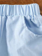 Light blue cotton baby shorts with elastic waistband and pocket detail.