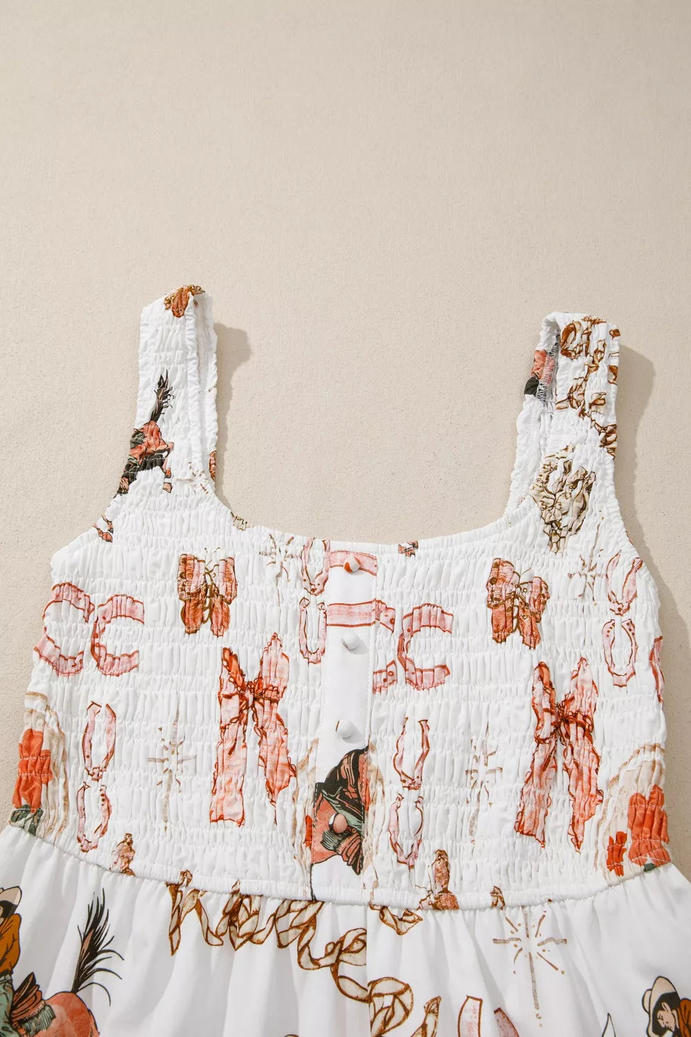 White cotton blend midi dress with cowboy-themed print, smocked bodice, and U-neck.