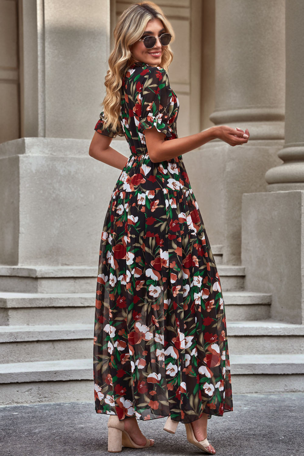 Black floral maxi dress with puff sleeves and tiered skirt.