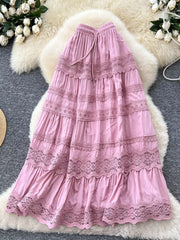 Pink tiered maxi skirt with lace trim and drawstring waist.