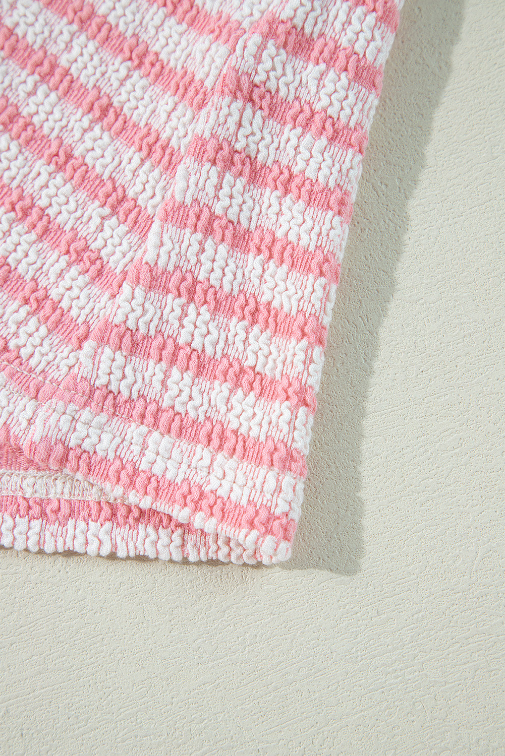 Textured stripe puff sleeve top in blush pink with smocked fabric detail.