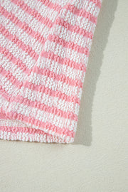 Textured stripe puff sleeve top in blush pink with smocked fabric detail.