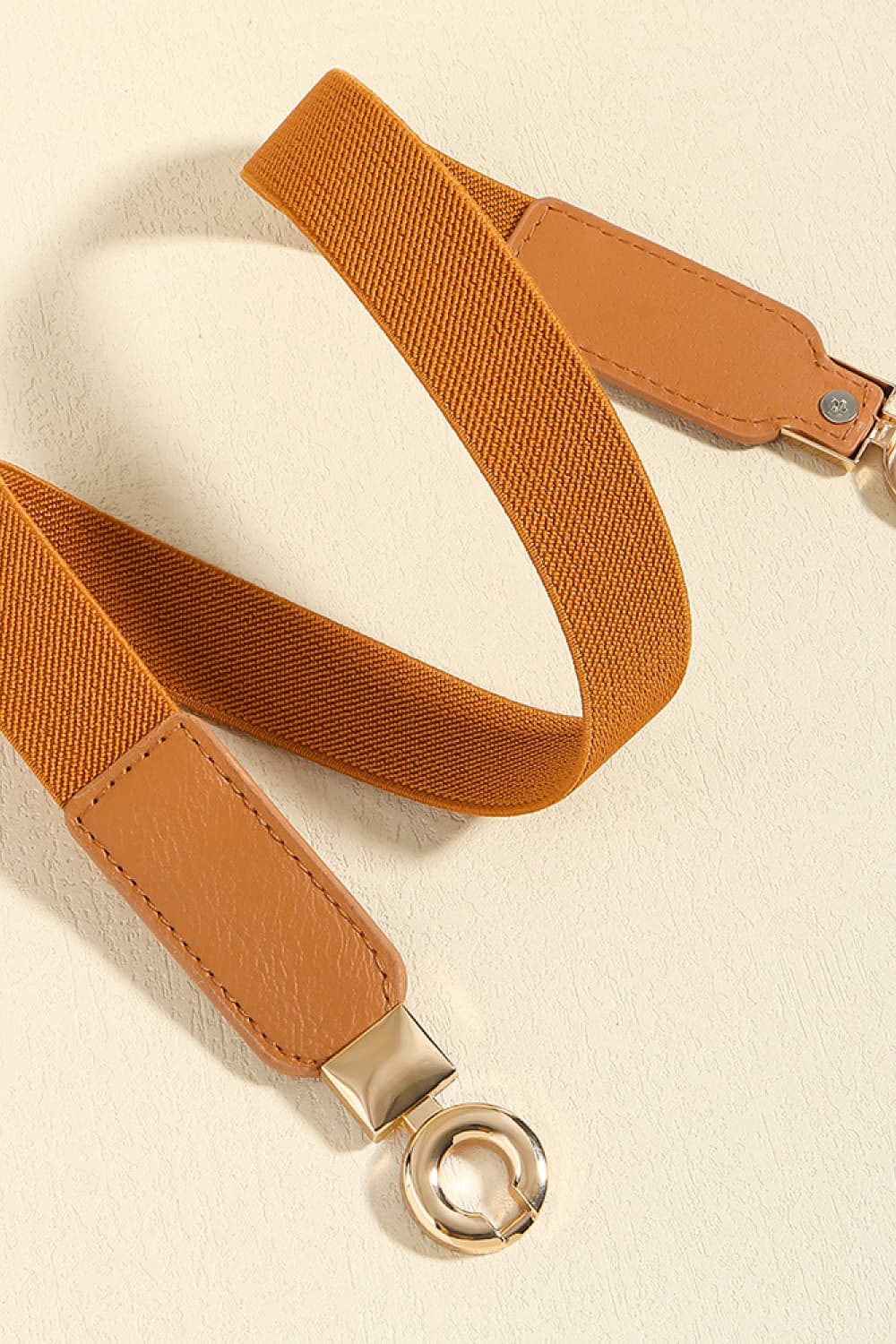 Caramel elastic belt with faux leather ends and gold hardware detail