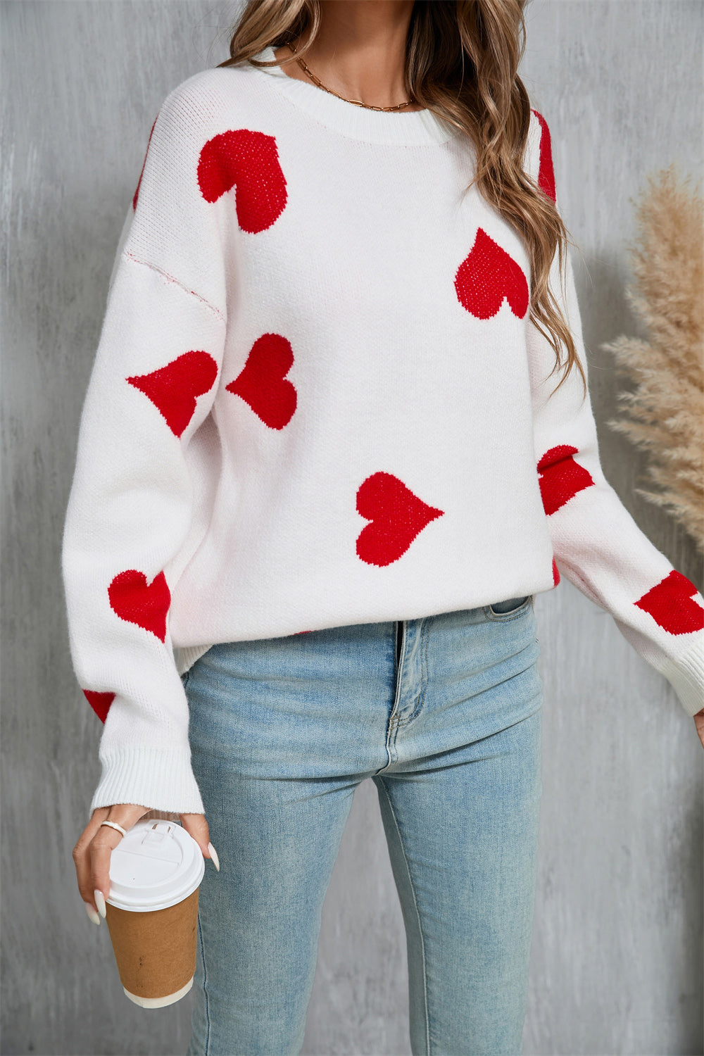 White acrylic knit jumper with red heart intarsia pattern, crew neck, long sleeves.