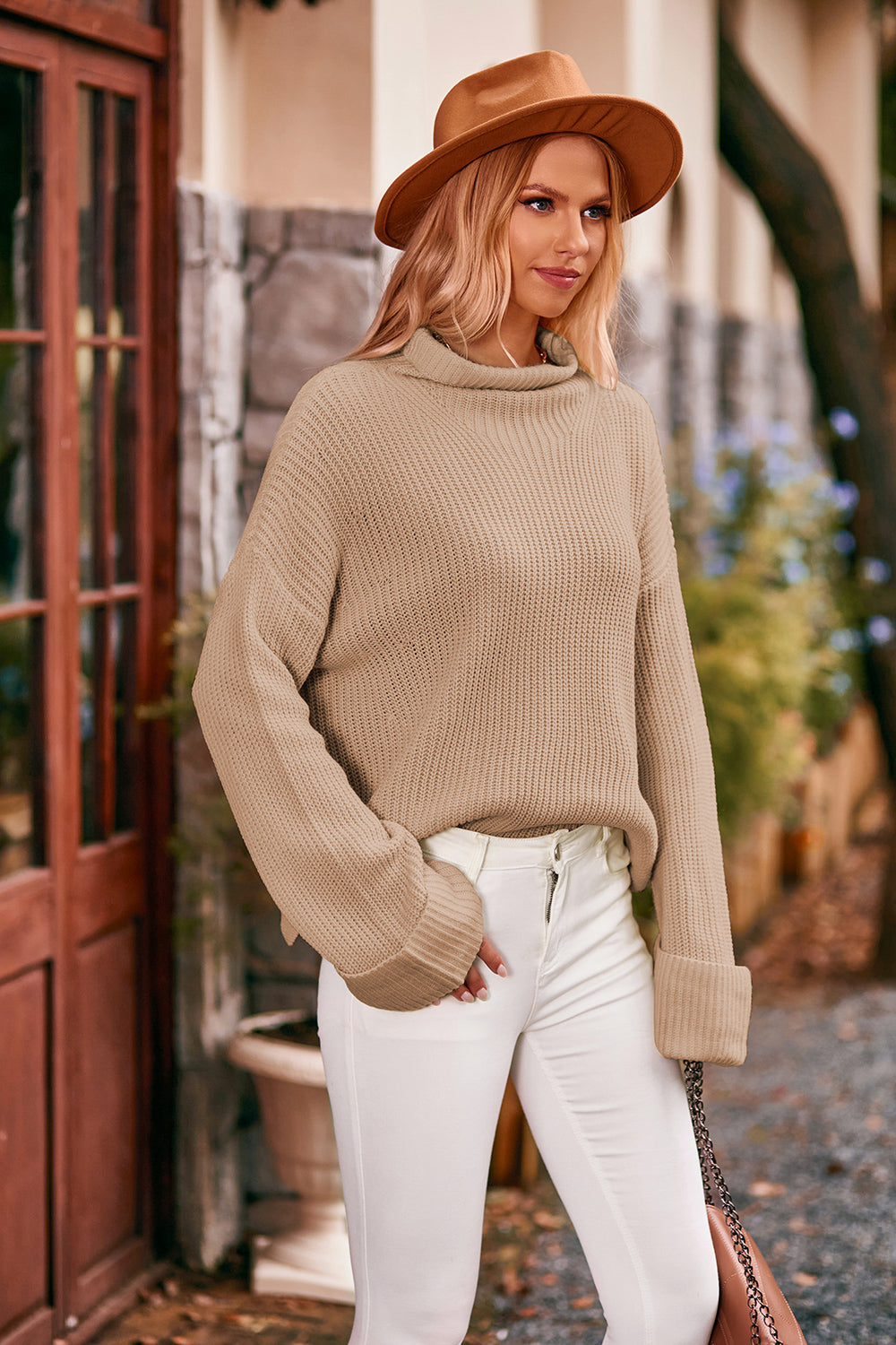 Khaki turtleneck sweater with cuffed sleeves and ribbed knit detail.
