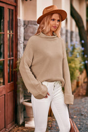 Khaki turtleneck sweater with cuffed sleeves and ribbed knit detail.