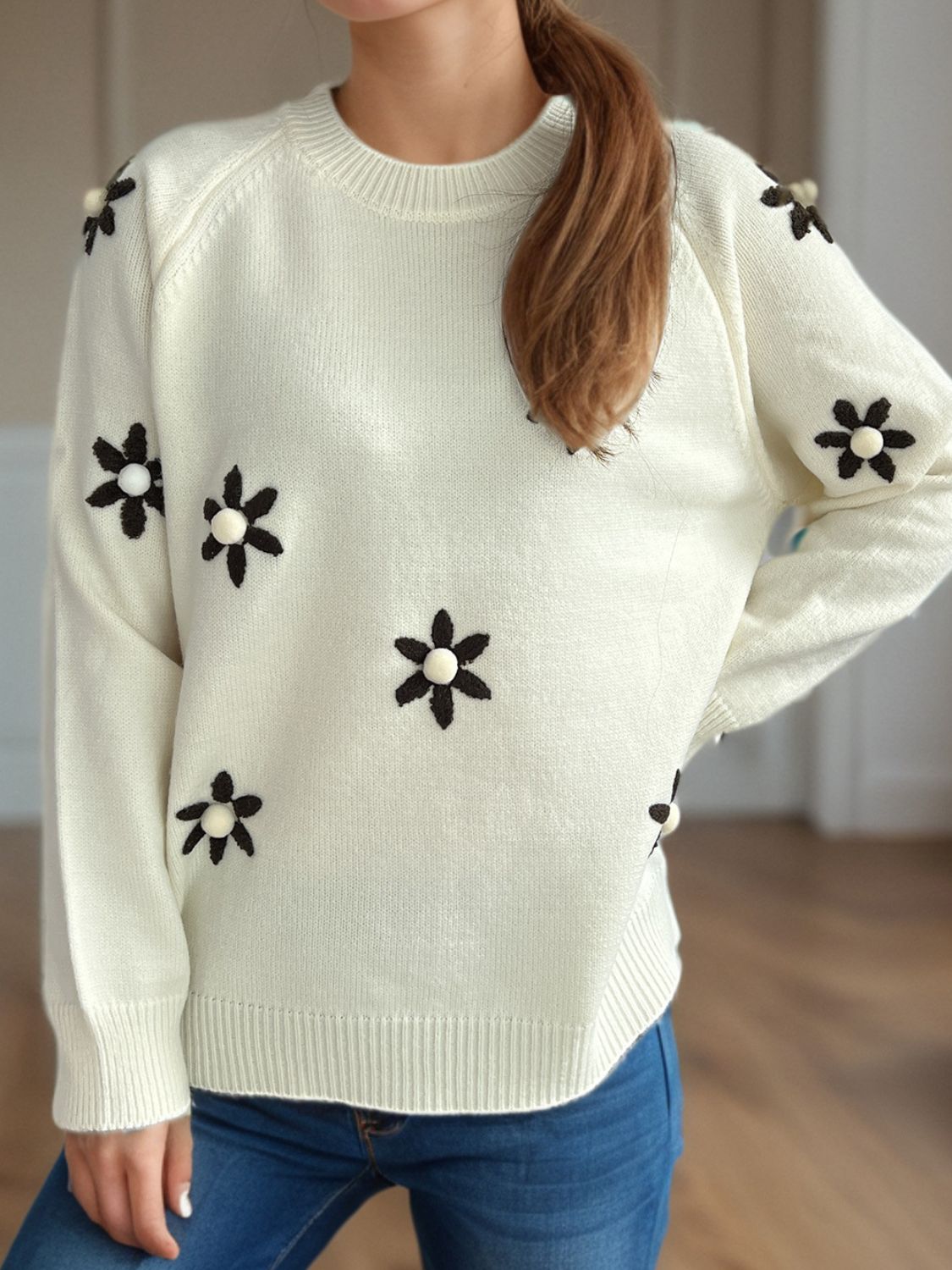 Cream embroidered floral raglan knit sweater with beaded flower details.