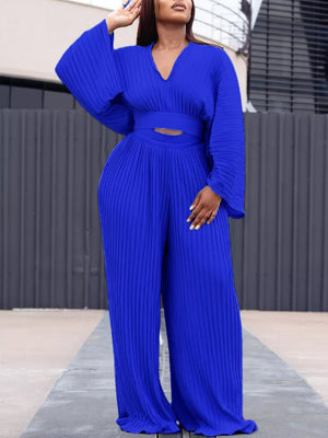 Blue pleated two-piece set with V-neck, wide sleeves, and wide-leg pants.