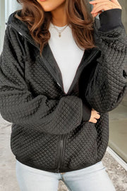 Black quilted zip-through hoodie with drawstring and ribbed cuffs.