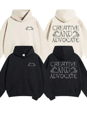 Black and beige oversized hoodies with embroidered skeleton hands forming a heart on the front and text on the back.
