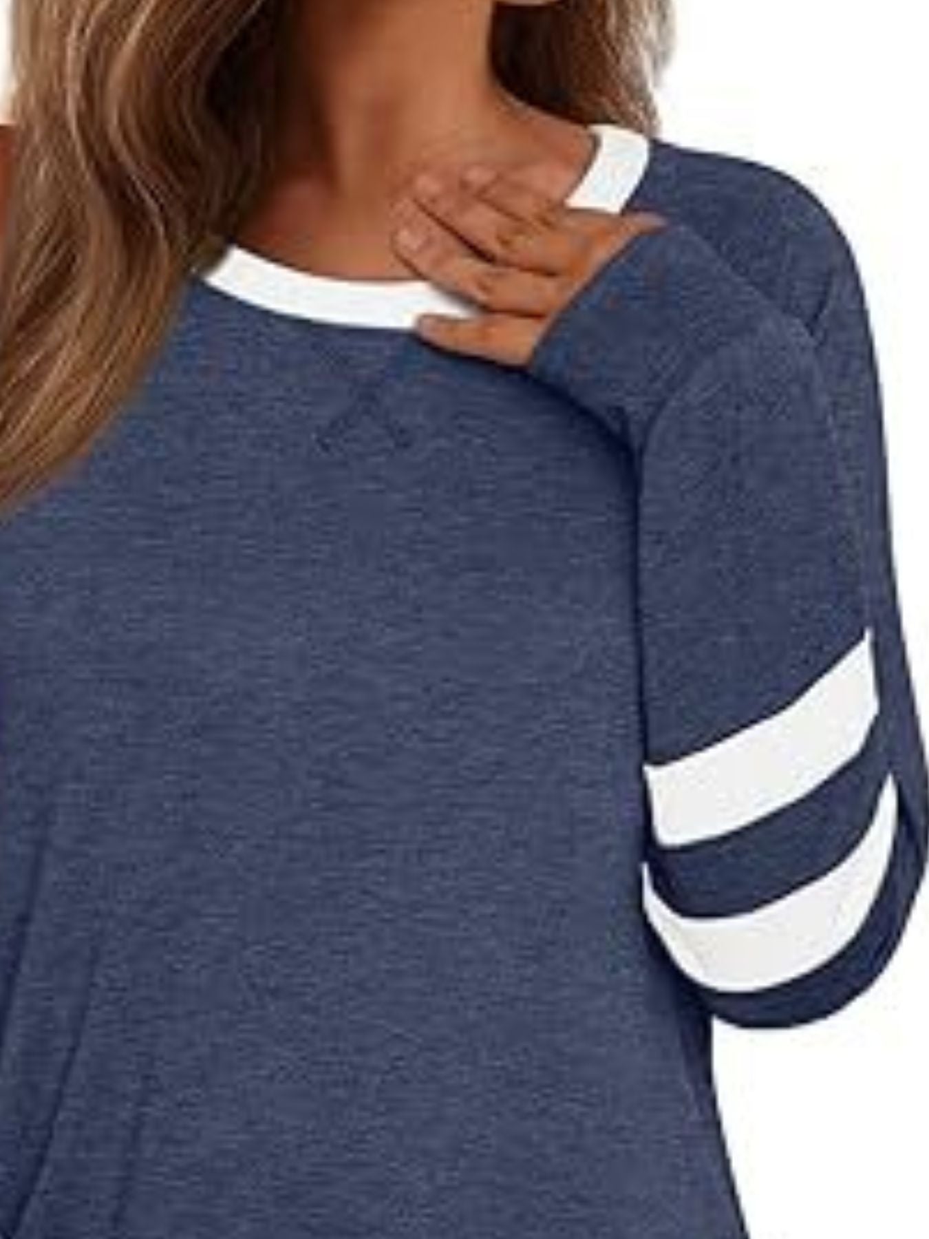 Heathered dark blue t-shirt with white neckline and striped sleeves.