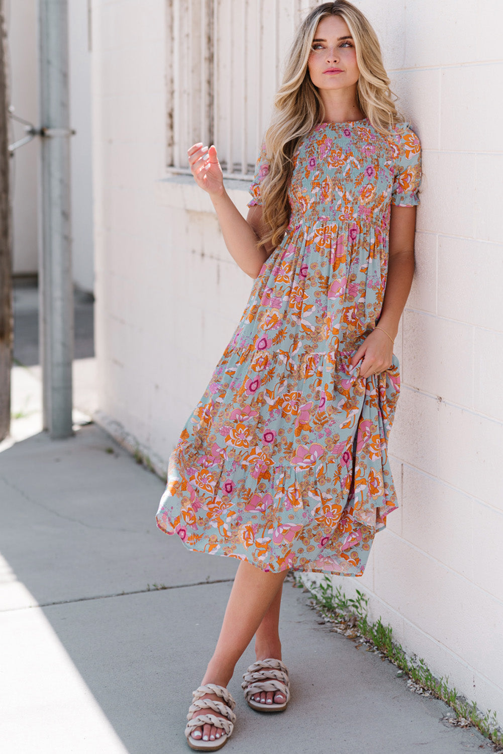 Floral smocked bodice tiered midi dress with short sleeves and a-line cut.
