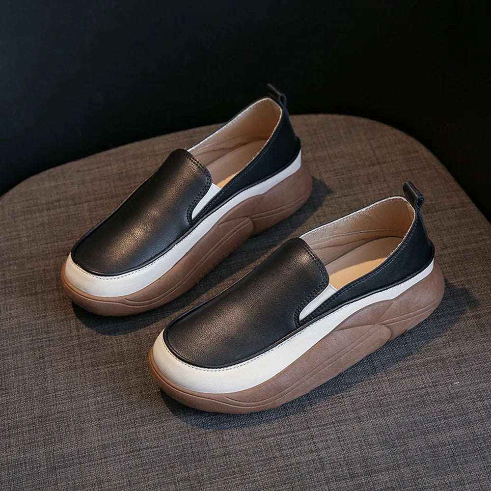 Black slip-on sneakers with white and brown platform soles