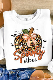 White crewneck sweatshirt with a leopard print pumpkin graphic and "Spooky vibes" text.