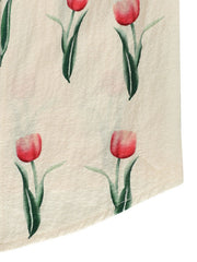 Cream midi dress with a red tulip print and textured fabric.