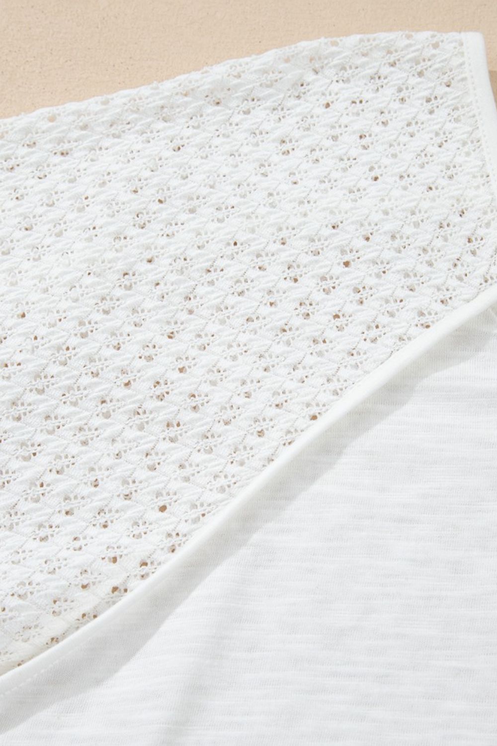 White lace-inset dolman sleeve blouse with a textured knit fabric detail.