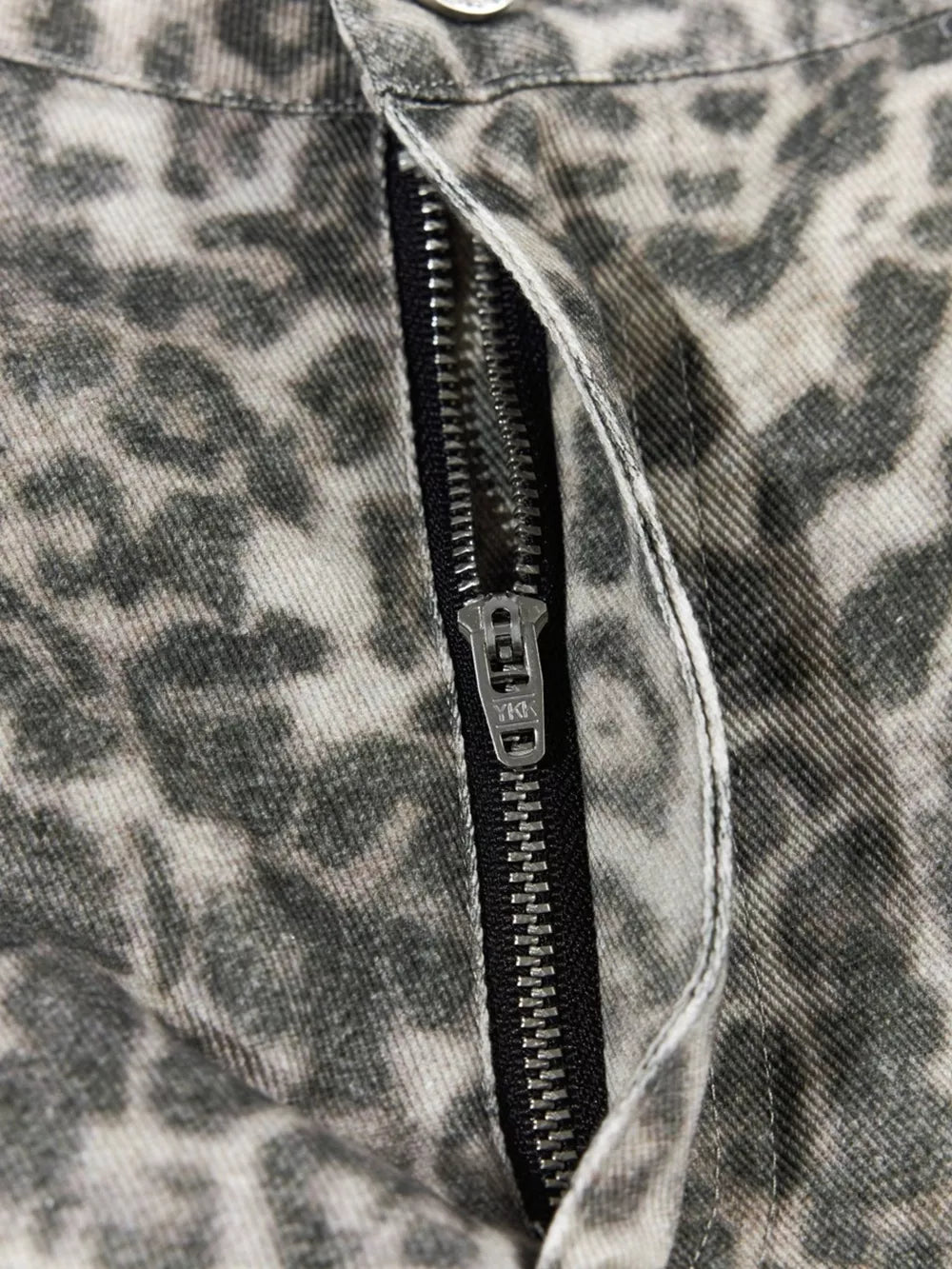 Leopard print cargo pants with a YKK zipper fly and utility pockets.