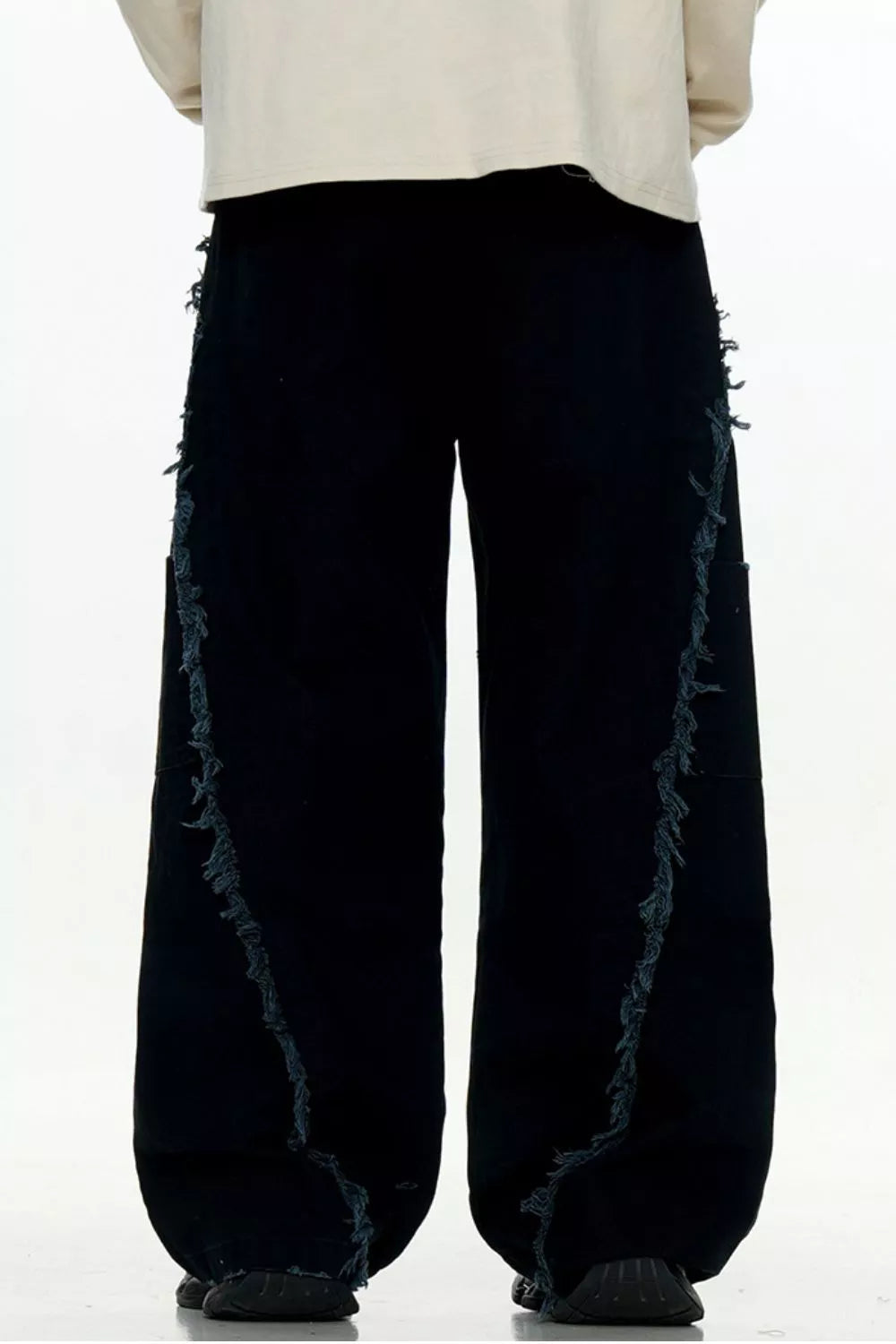 Black wide-leg sweatpants with distressed fringe detail on the sides.