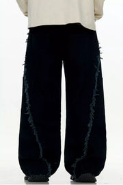 Black wide-leg sweatpants with distressed fringe detail on the sides.