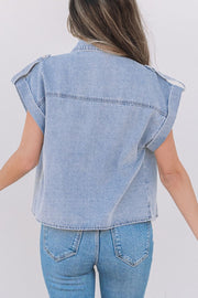 Light blue denim rolled-sleeve shirt jacket with shoulder epaulets and buttoned chest pockets.