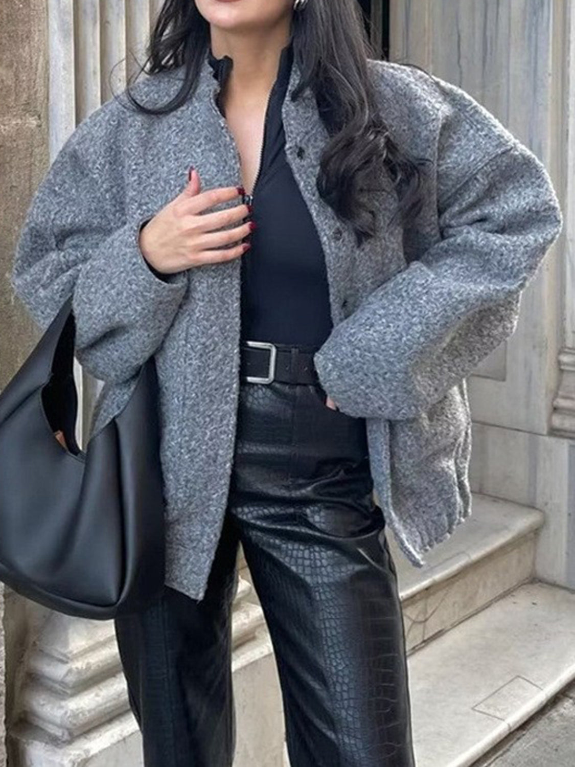 Bouclé cocoon jacket in dark gray with snap closure and stand collar.