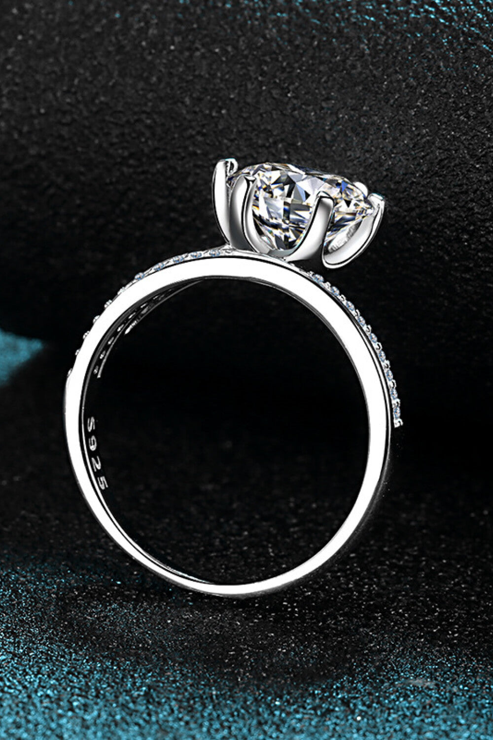 Silver bypass ring with pavé-set band and solitaire diamond.