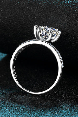 Silver bypass ring with pavé-set band and solitaire diamond.