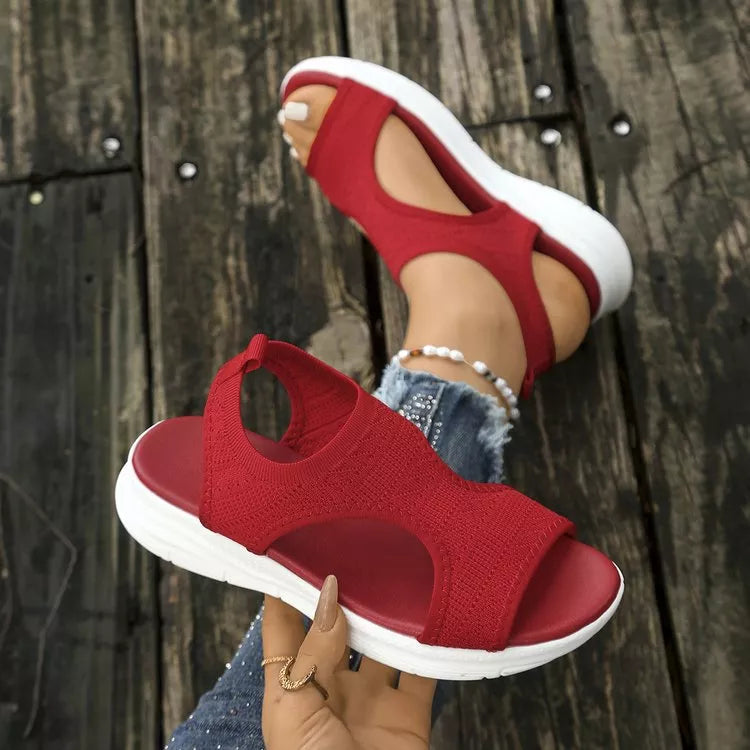 Red open-toe platform sandals with a knit upper and white sole.