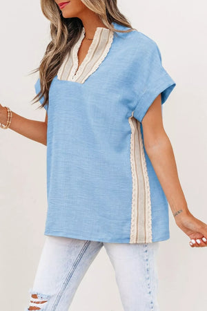 Blue polyester pullover shirt with V-neck, lace trim, and short sleeves.