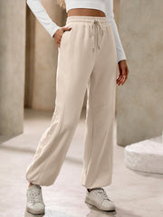 Tan balloon-leg sweatpants with drawstring waist and pockets
