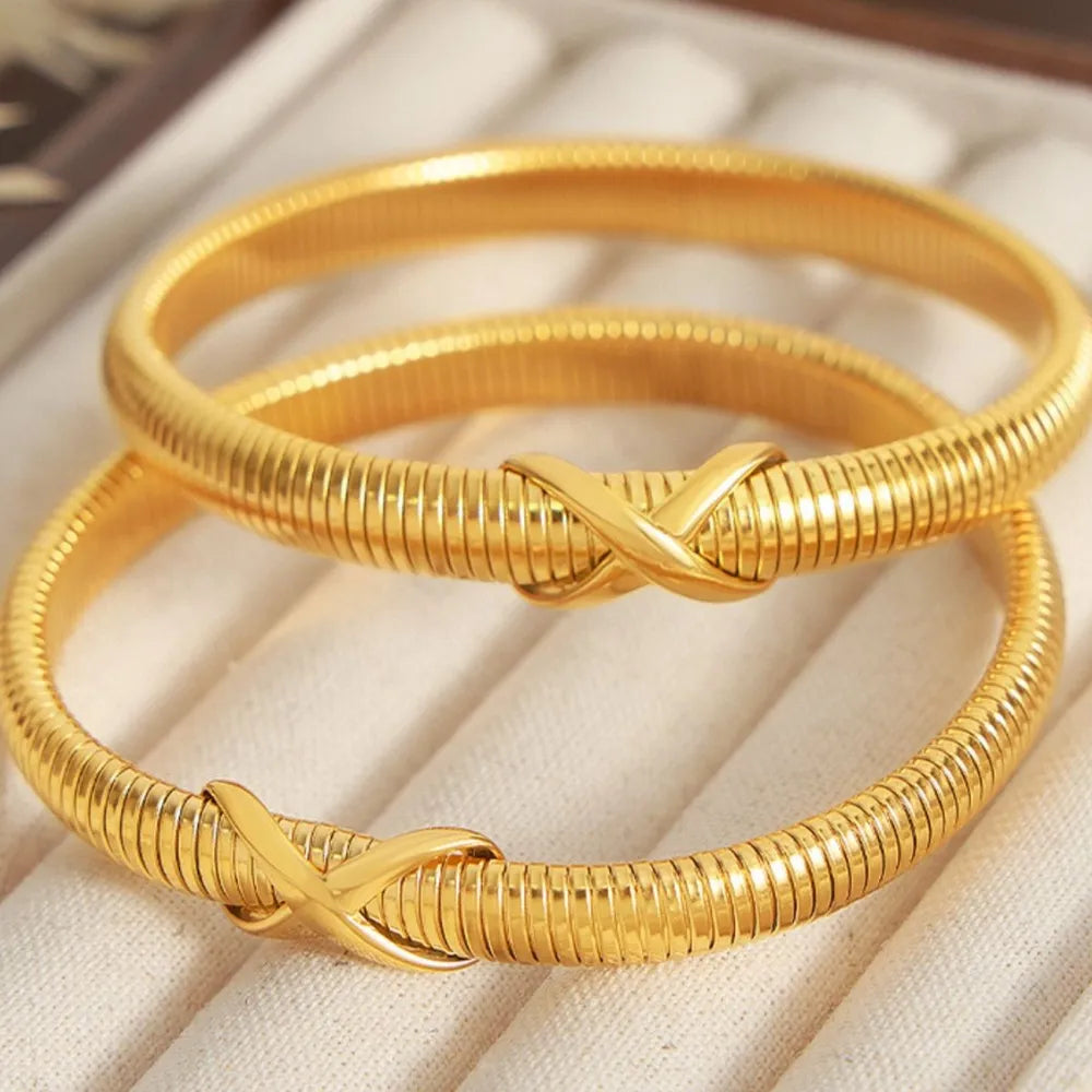 Gold ribbed bangle bracelet with X detail