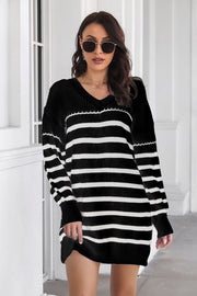 Black and white horizontal stripe knit mini dress with V-neck and long sleeves.