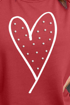 Scarlet sweatshirt with a white embellished heart graphic.