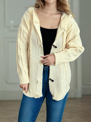 Beige cable knit hoodie with toggle closure and drawstring hood.