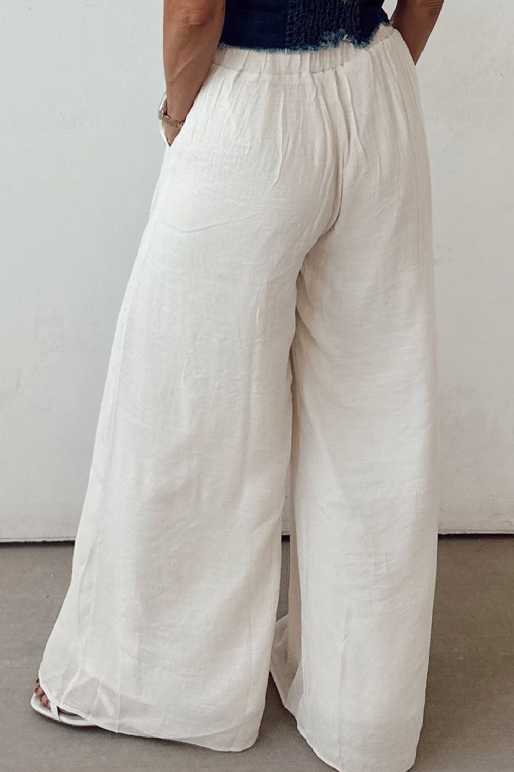 White linen palazzo trousers with elastic waist and wide leg